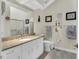 Bright bathroom featuring granite countertop, white cabinets, and a large mirror above the vanity at 515 Swim & Croquet, Pittsboro, NC 27312