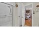 Bathroom view featuring a glass enclosed shower adjacent to a bedroom doorway at 515 Swim & Croquet, Pittsboro, NC 27312