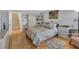 Spacious bedroom featuring parquet floors and a large bed with decorative pillows and furnishings at 515 Swim & Croquet, Pittsboro, NC 27312
