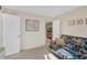 Bright bedroom features white doors, beige walls and carpet, and colorful sofa at 515 Swim & Croquet, Pittsboro, NC 27312