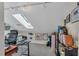 Bonus room with vaulted ceiling, skylight, track lighting, and built-in shelving at 515 Swim & Croquet, Pittsboro, NC 27312