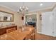 Cozy dining room featuring a wood table and chandelier near the living room at 515 Swim & Croquet, Pittsboro, NC 27312