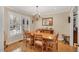 Bright dining room with wood table, chandelier, and a shuttered window at 515 Swim & Croquet, Pittsboro, NC 27312