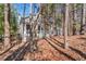 Exterior view of the home surrounded by mature trees and greenery in a peaceful setting at 515 Swim & Croquet, Pittsboro, NC 27312