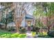 Charming home featuring a welcoming front porch, lush landscaping, and mature trees at 515 Swim & Croquet, Pittsboro, NC 27312