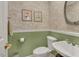 Neat half bathroom with floral wallpaper, a pedestal sink, and classic fixtures at 515 Swim & Croquet, Pittsboro, NC 27312
