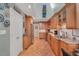 Spacious kitchen featuring wood cabinets, granite counters, and stainless steel appliances at 515 Swim & Croquet, Pittsboro, NC 27312