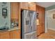 Kitchen with a stainless steel refrigerator and wood cabinets with granite countertops at 515 Swim & Croquet, Pittsboro, NC 27312