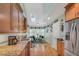 Bright kitchen with wood cabinets, granite countertops, stainless steel appliances, and a breakfast nook at 515 Swim & Croquet, Pittsboro, NC 27312