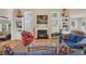 Inviting living room with a fireplace, built-in bookshelves, and a comfortable blue sofa at 515 Swim & Croquet, Pittsboro, NC 27312