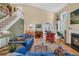 Open living room with fireplace, staircase, and a view of the dining area at 515 Swim & Croquet, Pittsboro, NC 27312