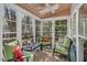 Screened porch with ceiling fan and natural light with green patio chairs at 515 Swim & Croquet, Pittsboro, NC 27312