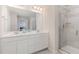 Bathroom featuring a double sink vanity, shower with glass door, and white cabinets at 609 Rawls Dr, Raleigh, NC 27610