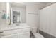 Clean bathroom with white cabinets, ample lighting, and neutral finishes at 609 Rawls Dr, Raleigh, NC 27610