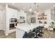 Modern kitchen with stainless steel appliances, white cabinetry, and a large island with pendant lighting at 609 Rawls Dr, Raleigh, NC 27610