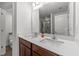 Double sink bathroom featuring quartz counters, modern fixtures, and a glass-enclosed shower at 6205 Taylor Rd, Wendell, NC 27591