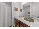 Well-lit bathroom featuring a quartz countertop, brown cabinets, mirror and neutral wall color at 6205 Taylor Rd, Wendell, NC 27591