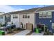Rear exterior view of townhomes with garages, driveways, and landscaping at 6205 Taylor Rd, Wendell, NC 27591