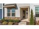 Inviting front entrance featuring stone accents, manicured landscaping, and a covered porch at 6205 Taylor Rd, Wendell, NC 27591