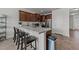 Kitchen island featuring granite counters, stainless appliances, barstool seating, and dark wood cabinetry at 6205 Taylor Rd, Wendell, NC 27591