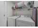 Functional laundry room with shelving, white walls, and washer and dryer units at 6205 Taylor Rd, Wendell, NC 27591