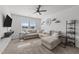 Bright living room with plush carpeting, a ceiling fan, and a large sectional sofa for relaxing at 6205 Taylor Rd, Wendell, NC 27591