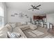 Open-concept living room featuring a ceiling fan, modern decor, and seamless flow into the kitchen at 6205 Taylor Rd, Wendell, NC 27591