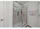 Modern shower stall with glass door, tile surround, and built-in shelving for toiletries at 6205 Taylor Rd, Wendell, NC 27591