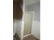 Bathroom featuring shower with glass door and white wainscoting at 6600 Coach Light Cir, Raleigh, NC 27613