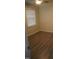 This bedroom features hardwood floors and a window with blinds, offering a cozy space at 6600 Coach Light Cir, Raleigh, NC 27613