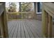New deck with wood railing overlooks a serene wooded setting and provides room for entertaining at 6600 Coach Light Cir, Raleigh, NC 27613
