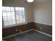 Dining room with chair rail molding, neutral paint, and a large window overlooking the backyard at 6600 Coach Light Cir, Raleigh, NC 27613