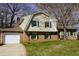 Charming brick home featuring well-manicured lawn and green shutters at 6600 Coach Light Cir, Raleigh, NC 27613