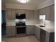 Stylish kitchen with stainless steel appliances and white countertops at 6600 Coach Light Cir, Raleigh, NC 27613