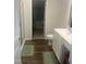 Well-lit bathroom featuring modern fixtures, a glass-enclosed shower, and wood-look flooring at 700 Cider Mill Way, Zebulon, NC 27597