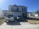 Charming two-story home features a well-maintained lawn, a two-car garage, and a welcoming front porch at 700 Cider Mill Way, Zebulon, NC 27597
