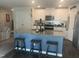 Modern kitchen with a blue island, granite countertop, stainless steel appliances, and white cabinets at 700 Cider Mill Way, Zebulon, NC 27597