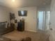 Comfortable living room with a television, dark sofa, and access to two hallways with white doors at 700 Cider Mill Way, Zebulon, NC 27597