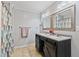 Bathroom featuring double sink vanity with modern fixtures, decorative mirrors, and tiled floor at 7155 Old Fairground Rd, Benson, NC 27504