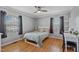 Bright bedroom with hardwood floors, a ceiling fan, and windows that offer plenty of natural light at 7155 Old Fairground Rd, Benson, NC 27504