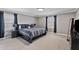 Cozy bedroom featuring neutral walls, soft carpeting, and natural light from the windows with curtains at 7155 Old Fairground Rd, Benson, NC 27504