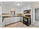 Functional kitchen featuring white cabinets and modern appliances at 7155 Old Fairground Rd, Benson, NC 27504