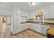 Bright kitchen with white cabinets and modern appliances at 7155 Old Fairground Rd, Benson, NC 27504