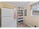 Pantry with a side-by-side refrigerator and well-organized shelving for pantry items, and a window at 7155 Old Fairground Rd, Benson, NC 27504