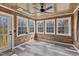 Bright sunroom with wood paneled walls and multiple windows for natural light at 7155 Old Fairground Rd, Benson, NC 27504
