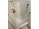 Bright, tiled bathtub and shower with built-in shelving for storage at 829 S Franklin St, Wake Forest, NC 27587