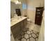 Modern bathroom design with dual sinks, cabinet storage, and decorative doll accents at 829 S Franklin St, Wake Forest, NC 27587