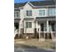 Charming townhome with a stylish exterior, including brick accents, siding and inviting front steps at 829 S Franklin St, Wake Forest, NC 27587