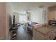 Cozy living room features a large grey couch, ceiling fan and a large window providing ample natural light at 829 S Franklin St, Wake Forest, NC 27587