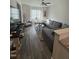 Bright living room features a large grey couch, ceiling fan and a large window providing ample natural light at 829 S Franklin St, Wake Forest, NC 27587
